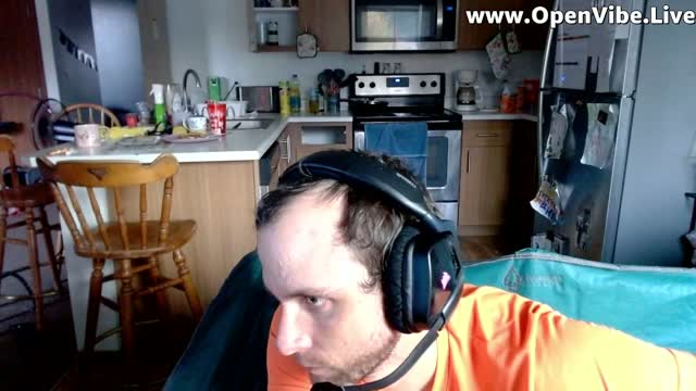 A Person Wearing Headphones Sits In A Living